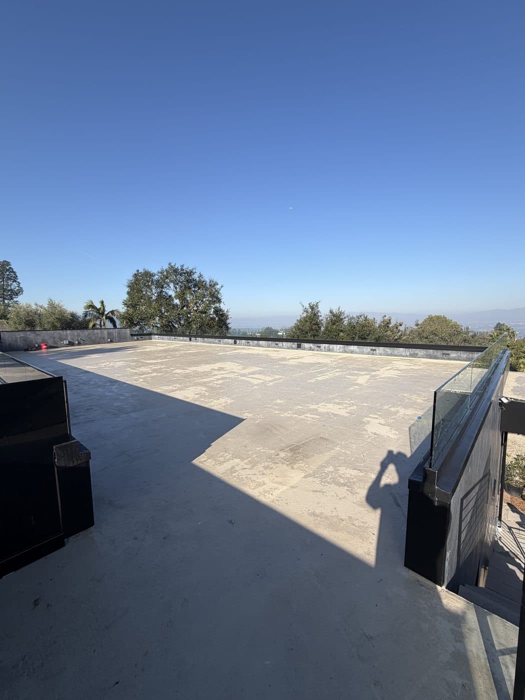 A rooftop deck with a frameless glass rail and valley views, cleaned by Window Wizards