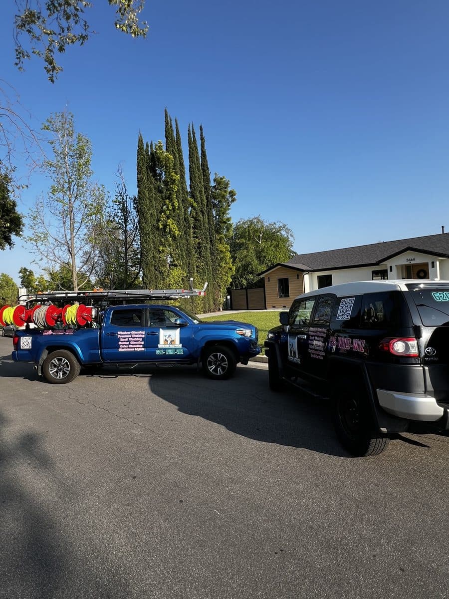 The Window Wizards branded fleet, a wrapped Tacoma and SUV parked outside a Los Angeles home