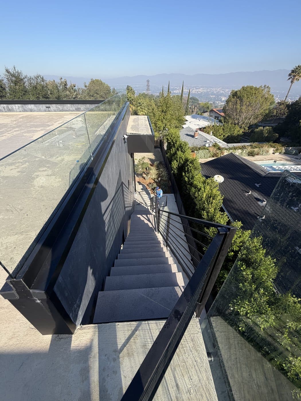 Frameless glass deck railings cleaned by Window Wizards on a hillside Los Angeles home